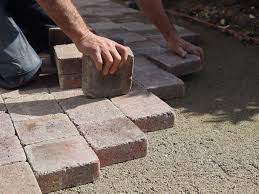 Lakeland Paver Pros team efficiently installing pavers in an outdoor landscape, showcasing their hassle-free and precise installation services.